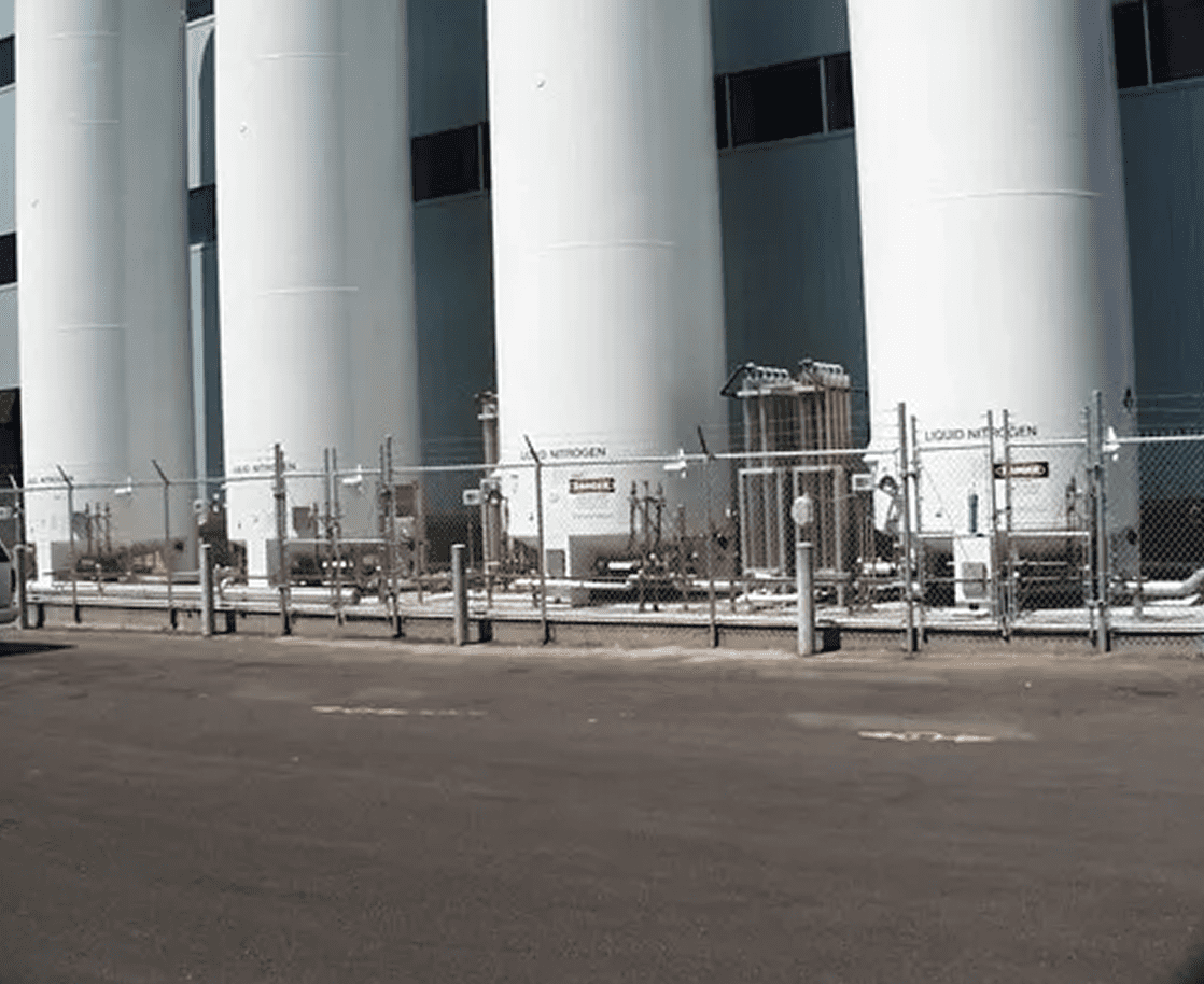 White cylindrical tanks in industrial area